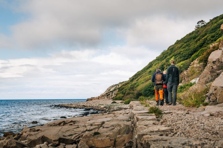 people hiking in autumn by the lake